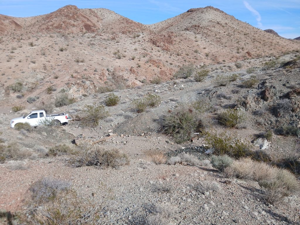 The Deep Dynamite claim ground in the Eldorado Mountains, Clark County, Nevada, with a truck parked on the access route